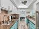 Bright kitchen featuring blue cabinets, stainless steel appliances, and recessed lighting at 6832 Woodwind Dr # 53, Sarasota, FL 34231