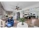 Open-concept living room with sunroom and dining area, great for entertaining and relaxing at 6832 Woodwind Dr # 53, Sarasota, FL 34231