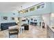 Open concept living room and dining area with high ceilings, tile flooring, and ample natural light at 6832 Woodwind Dr # 53, Sarasota, FL 34231