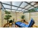 Relaxing covered patio features a lounge chair, small table, potted plants, privacy fence, and natural light at 6832 Woodwind Dr # 53, Sarasota, FL 34231