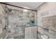 Modern shower with gray stone tiles, glass door, rainfall shower head and convenient grab bar at 6832 Woodwind Dr # 53, Sarasota, FL 34231