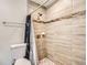 Shower room with shower head, stone floor, and tiled walls at 718 17Th E St, Bradenton, FL 34208
