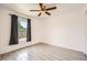 Bedroom with wood-look tile floors, neutral walls, a window, and ceiling fan at 718 17Th E St, Bradenton, FL 34208