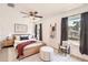 Bright bedroom with wood-look floors, a ceiling fan, and a stylishly decorated bed with warm accents at 718 17Th E St, Bradenton, FL 34208