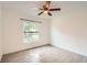 Bright bedroom featuring wood-look floors, a ceiling fan, and a large window at 718 17Th E St, Bradenton, FL 34208
