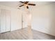 This bedroom features wood-look tile floors, white walls, a ceiling fan and closet at 718 17Th E St, Bradenton, FL 34208