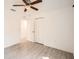 Bright bedroom with wood-look floors, a ceiling fan, and closet doors at 718 17Th E St, Bradenton, FL 34208