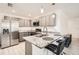 Modern kitchen with stainless steel refrigerator and granite countertops at 718 17Th E St, Bradenton, FL 34208