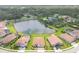 Aerial shot of homes surrounding a pond in a neighborhood with lush trees offering a serene environment at 7228 Great Egret Blvd, Sarasota, FL 34241
