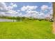 Expansive backyard with a picturesque lake view, perfect for outdoor activities at 7228 Great Egret Blvd, Sarasota, FL 34241