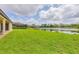 Lush backyard with a serene lake view, ideal for outdoor enjoyment at 7228 Great Egret Blvd, Sarasota, FL 34241