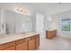 Bright bathroom featuring double sink vanity with lots of cabinet space, large mirror, tile floor and recessed lighting at 7228 Great Egret Blvd, Sarasota, FL 34241