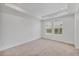 Bright bedroom with tray ceiling, neutral carpet, and large windows at 7228 Great Egret Blvd, Sarasota, FL 34241