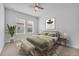 Cozy bedroom featuring a ceiling fan, complemented by a comfortable bed with bench seating at 7228 Great Egret Blvd, Sarasota, FL 34241