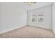 Unfurnished bedroom with neutral walls, carpet and two windows at 7228 Great Egret Blvd, Sarasota, FL 34241