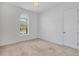 Bright bedroom featuring neutral carpet, ceiling fan and lots of natural light from the window at 7228 Great Egret Blvd, Sarasota, FL 34241