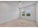 Bright bedroom features natural light from the windows and neutral finishes, carpeted floor and ceiling fan at 7228 Great Egret Blvd, Sarasota, FL 34241