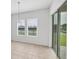 Bright dining area features tile flooring, a modern light fixture, and sliding glass doors at 7228 Great Egret Blvd, Sarasota, FL 34241