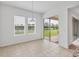 Bright dining area features tile flooring, two windows, and sliding glass doors to the patio at 7228 Great Egret Blvd, Sarasota, FL 34241
