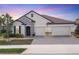Beautiful single-Gathering home with a brick driveway, a tile roof, stone accents and a two-car garage at 7228 Great Egret Blvd, Sarasota, FL 34241
