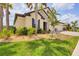 A single-Gathering home enhanced by lush landscaping, a stone facade, and a two-car garage at 7228 Great Egret Blvd, Sarasota, FL 34241