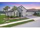 Charming single-Gathering home with a tile roof, stone accents, a three-car garage, and lush landscaping at 7228 Great Egret Blvd, Sarasota, FL 34241