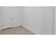 Neutral hallway featuring tile floors, white walls, and a white door at 7228 Great Egret Blvd, Sarasota, FL 34241
