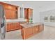Well-equipped kitchen with stainless steel appliances, a center island, and natural lighting at 7228 Great Egret Blvd, Sarasota, FL 34241