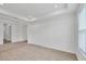 Spacious living room with neutral carpet, tray ceiling, and large windows at 7228 Great Egret Blvd, Sarasota, FL 34241