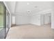 An open living room with carpet flooring, recessed lighting, and sliding glass doors with access to the backyard at 7228 Great Egret Blvd, Sarasota, FL 34241