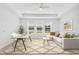Bright living room boasts large windows, modern ceiling fan, and comfortable furniture at 7228 Great Egret Blvd, Sarasota, FL 34241