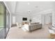 A bright living room with neutral decor, recessed lighting, and sliding glass doors to the backyard at 7228 Great Egret Blvd, Sarasota, FL 34241