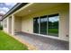 Covered patio with brick flooring and sliding doors offers seamless outdoor living at 7228 Great Egret Blvd, Sarasota, FL 34241