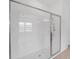 Modern shower features glass doors, white tile and multiple shower heads, offering a spa-like experience at 7228 Great Egret Blvd, Sarasota, FL 34241
