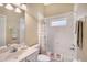 Bright bathroom with a vanity sink, a tub and shower combo and coordinated towel set at 7464 Ridge Rd, Sarasota, FL 34238