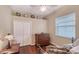 Cozy bedroom with a ceiling fan, a window with blinds and wooden floors at 7464 Ridge Rd, Sarasota, FL 34238