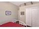 Bedroom featuring a cozy bed, neutral paint, and a white closet with doors at 7464 Ridge Rd, Sarasota, FL 34238