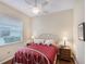 Comfortable bedroom bathed in natural light, with a cozy bed and dark wood nightstands at 7464 Ridge Rd, Sarasota, FL 34238