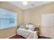 Relaxing bedroom with natural light from the window with blinds, complemented by hardwood floors at 7464 Ridge Rd, Sarasota, FL 34238