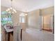 Open-concept dining area with a view of the front entrance and access to other rooms at 7464 Ridge Rd, Sarasota, FL 34238