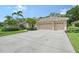 Charming home featuring a well-manicured lawn, lush landscaping, and a spacious three-car garage at 7464 Ridge Rd, Sarasota, FL 34238