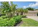 Charming home featuring a well-manicured lawn, lush landscaping, and a spacious three-car garage at 7464 Ridge Rd, Sarasota, FL 34238