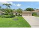 Charming home featuring a well-manicured lawn, lush landscaping, and a spacious three-car garage at 7464 Ridge Rd, Sarasota, FL 34238