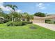 Charming home featuring a well-manicured lawn, lush landscaping, and a spacious three-car garage at 7464 Ridge Rd, Sarasota, FL 34238