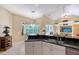 Bright kitchen with an island, bar seating, and a view of the backyard at 7464 Ridge Rd, Sarasota, FL 34238