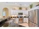Modern kitchen with stainless steel appliances, granite counters, and a view of the breakfast area at 7464 Ridge Rd, Sarasota, FL 34238