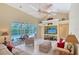 Inviting living room with a view of the pool, comfortable seating and a custom entertainment center at 7464 Ridge Rd, Sarasota, FL 34238
