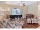 Bright living room featuring a piano, hardwood floors, and views of the lanai with outdoor kitchen at 7464 Ridge Rd, Sarasota, FL 34238