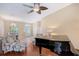 Inviting living room with a grand piano, comfortable armchairs, and ample natural light at 7464 Ridge Rd, Sarasota, FL 34238