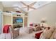 Bright living room features a large TV, comfortable seating, and unique ceiling fan for a relaxing space at 7464 Ridge Rd, Sarasota, FL 34238